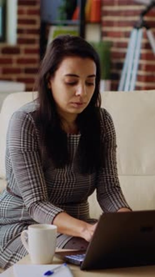 Woman Working on Laptop at Home