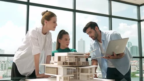 Team of Architects Collaborate on Building Model in Office