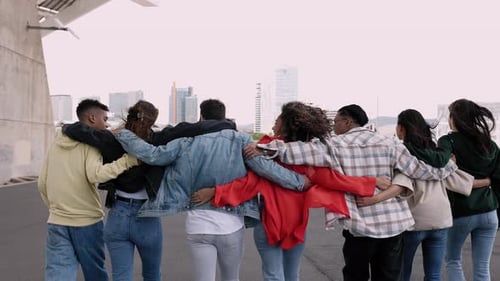 Diverse Friends Walking Arm in Arm in City