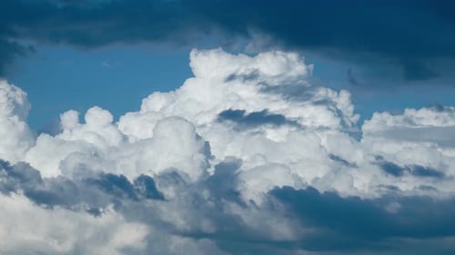 White Cumulus Clouds Moving in a Blue Sky