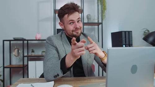 Businessman Working on Office Laptop Pointing to Camera Looking with Happy Expression Making Choice