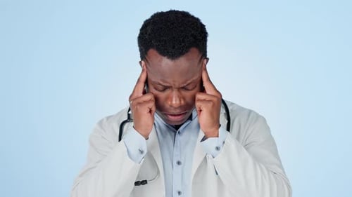 Black man, doctor and headache in stress, mistake or burnout against a studio background