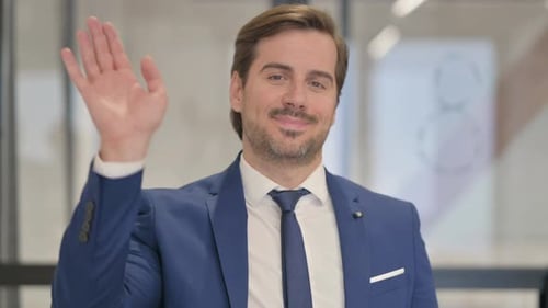 Portrait of Young Businessman Waving Hand to Welcome