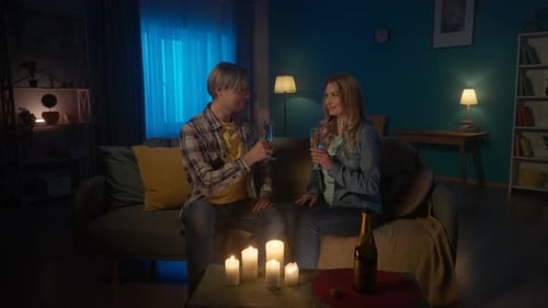 Couple Celebrates with Champagne in Cozy Living Room