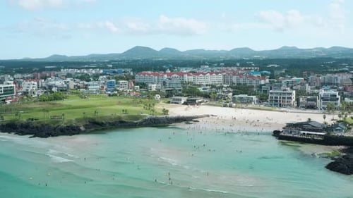 A landscape of the beach and city center of Jeju Island, South Korea. Hamdeok Beach.
