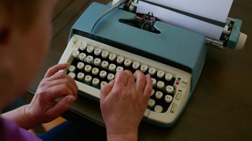 Close Up Footage of Elderly Woman Typing on Vintage Typewriter