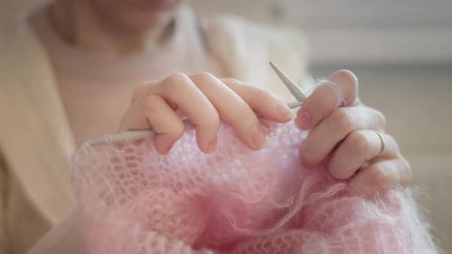 Soft Light Close Up of Hands Knitting Wool Fabric