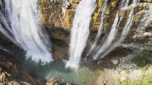 Aerial View of Waterfall Cascading Over Cliffs