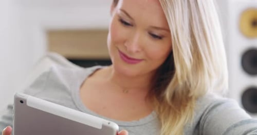 Woman Using Tablet Device Smiling in Home