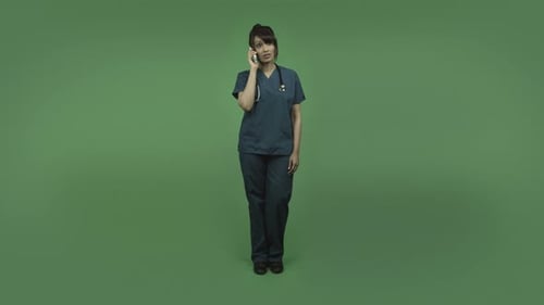 Woman in Scrubs Talking on Phone in Studio