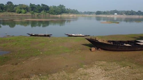 A sand-filled river flows through a rural environment.