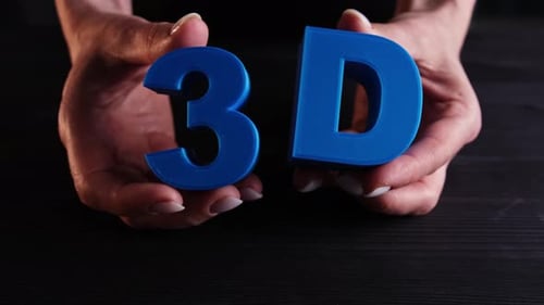 Hands Manipulate a 3D Print of Text