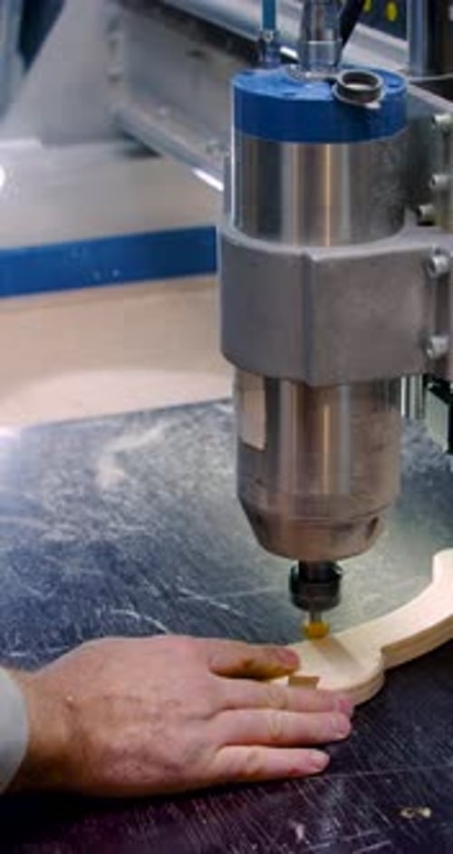 CNC Machine Cutting Wood with Guiding Hand