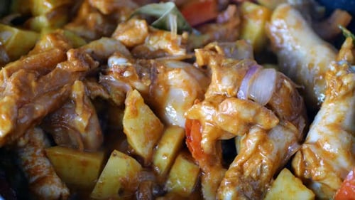 Chicken and Potatoes Cooking in a Pan