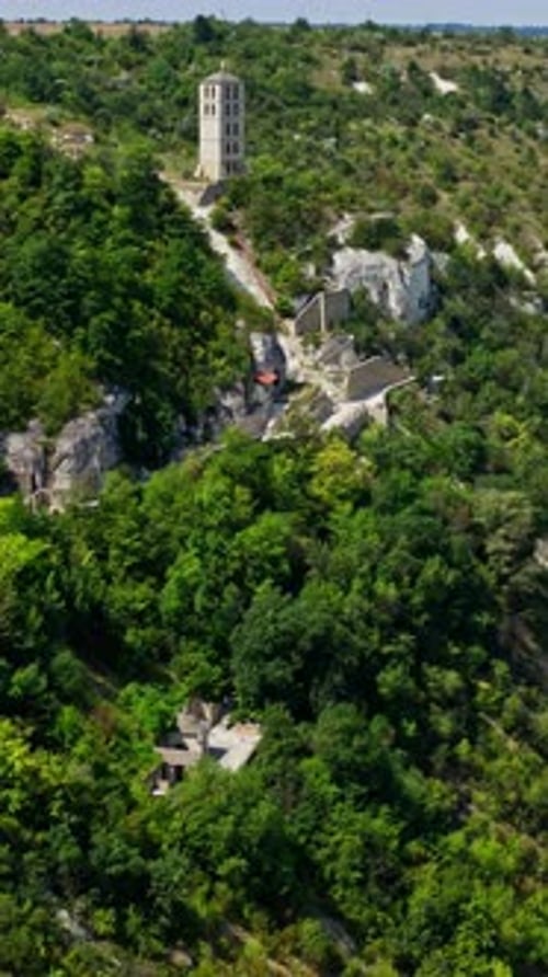 Aerial view of rock monastery. Beautiful mountainous landscape with rocky cliffs. Vertical video