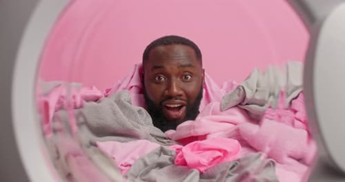 Man looking out from inside washing machine