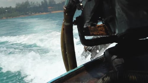 Thailand engine on a Longtailboat driving away from beach, close-up