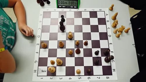 Teenagers play chess. Chess game view from above