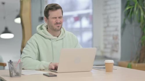 Young Adult Typing at Computer with Neck Pain