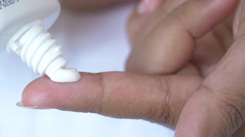 Close Up of Person Hand Using Sunscreen Cream Outdoor