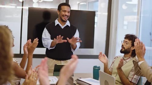 Cheerful Business Team Clapping Hands in Modern Office