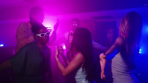 Friends Dancing Together in Vibrant Nightclub