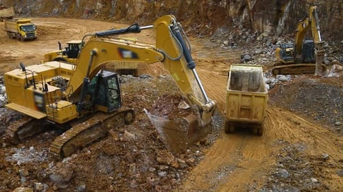 Excavator Loads Rocks Into Truck