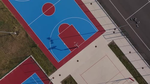 Drone rise up above sports courts in my neighbourhood.