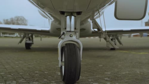 Close up dolly shot of luxury cessna citation jet parking at airport during cloudy day.