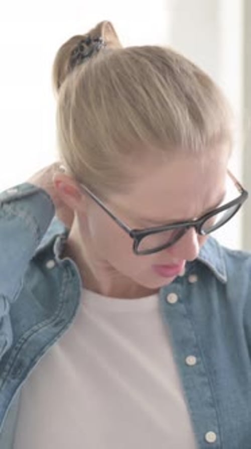 Woman Massaging Stiff Neck For Relief