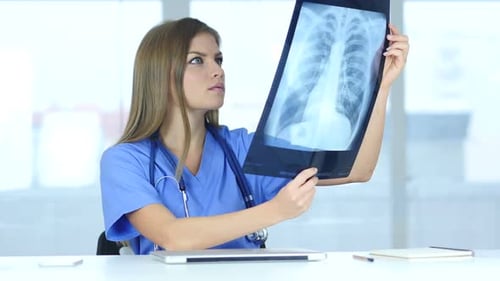 Woman Doctor Inspecting Chest X-Ray in Office