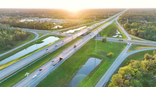 View From Above of Busy American Highway Bridge with Fast Moving Traffic in Green Florida Area in