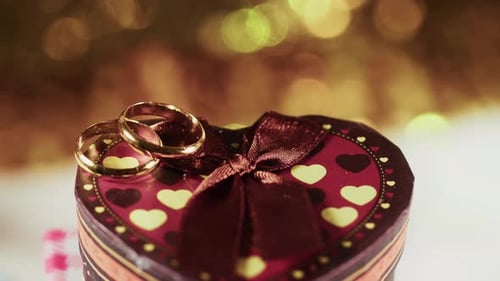 Wedding Rings on Heart Gift Box Close Up