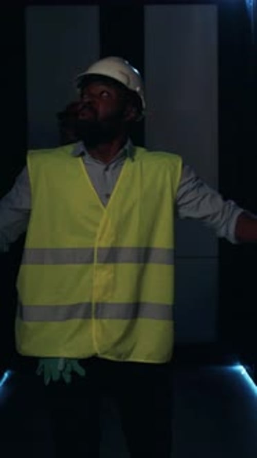 A Construction Worker Dressed in Proper Safety Gear Depicted in a Dimly Lit Setting