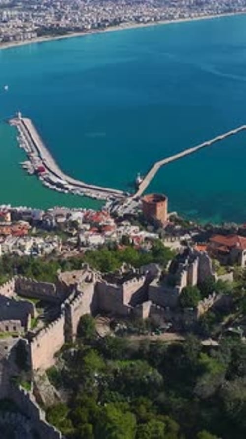 Vertical Video Aerial Perspective of Alanya s Hilltop Fortress With Stunning Views of the City and