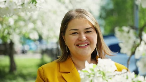 Business Woman Portrait in Blossoming Apple Trees