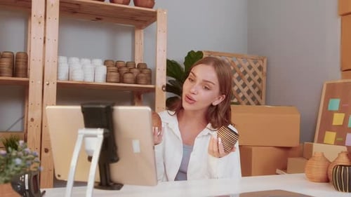 Young Adult Reviews Crafts on Tablet Video Call