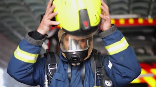 Firefighter Prepares, Removes Mask in Firehouse