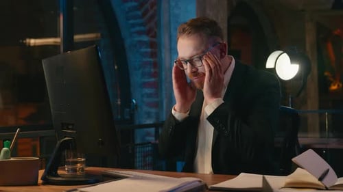 Caucasian Business Man Stressed Feeling Headache Working Computer in Night Evening Office Deadline