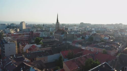 Novi Sad city roofs and church in fog