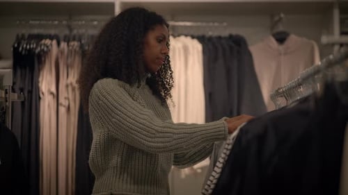 A Stylish Woman Shops for the Latest Trendy Clothing and Accessories in a Modern Retail Store