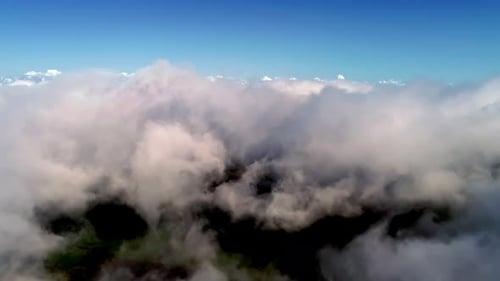 Aerial View Above Fluffy White Clouds and Blue Sky