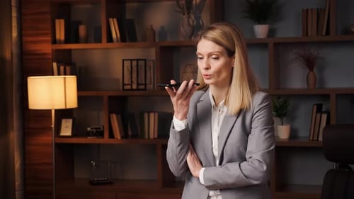 Professional Woman Using Phone in Office Setting