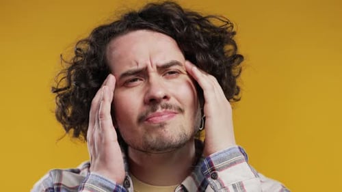 Young Man Having Headache Yellow Studio Portrait Sick Guy Puts Hands on Head
