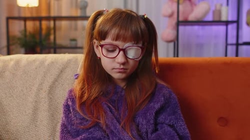 Young Girl with Eye Patch on the Couch