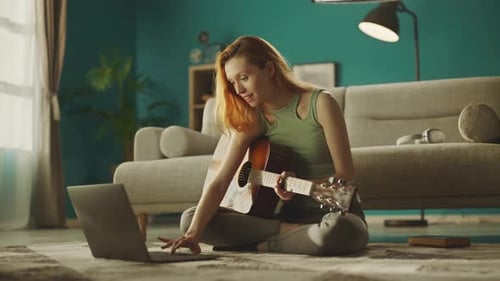 Woman Plays Guitar with Online Lesson at Home