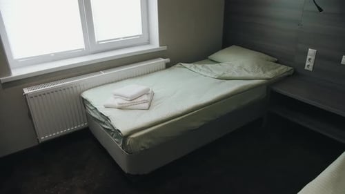 The bed is in the hotel. A two-bed room waiting for guests. Two made-up beds in the apartment.