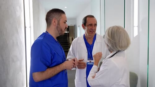 Medical team collaborating in a bright hospital hallway