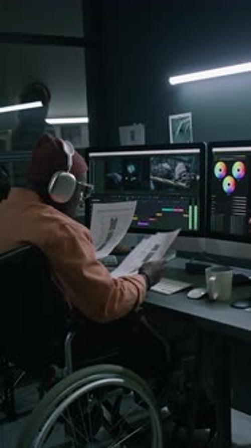 Editor in Wheelchair Working at Computer