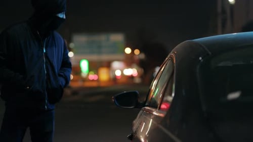An Enigmatic Figure Appears Amidst the Dark Urban Surroundings Filled with Mystery and Suspense
